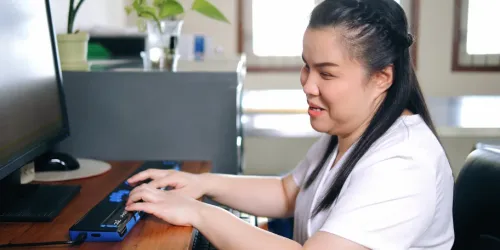 Blind woman using assistive computer device